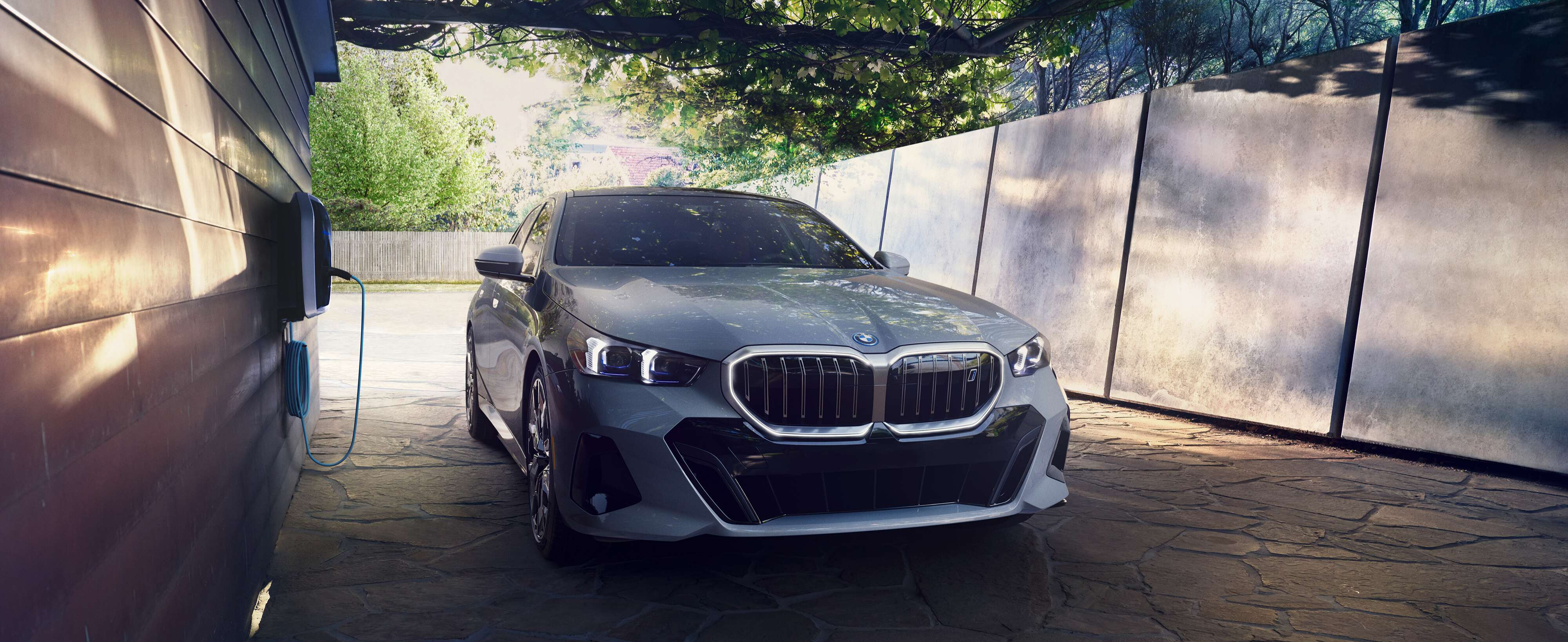 Pre-Owned BMW Sedans BMW Sedan parked at a home charging station in a driveway