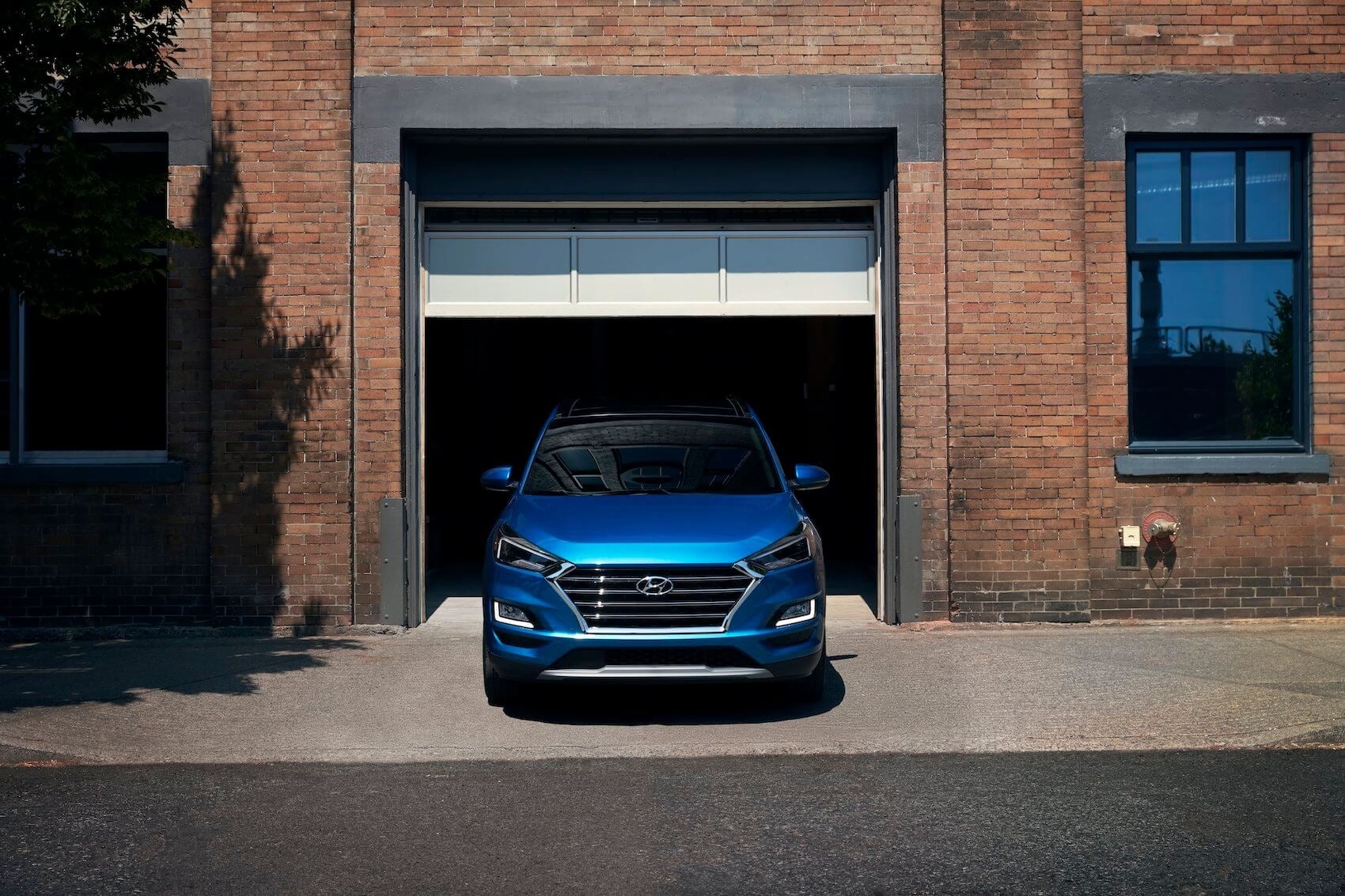 Hyundai Tucson front view coming out of a garage