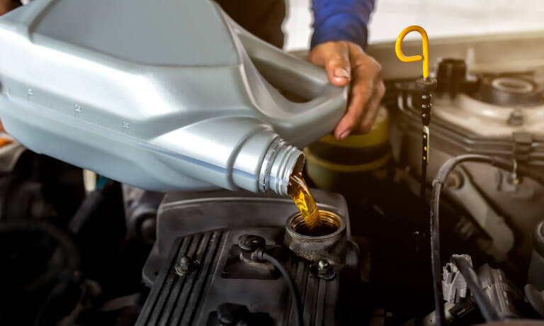 Service tech performing oil change