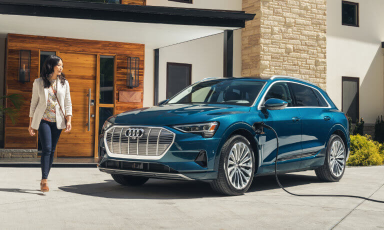 2023 Audi e-tron charging infront of a house