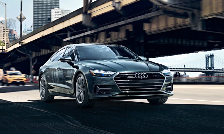2023 Audi A7 exterior driving by a bridge