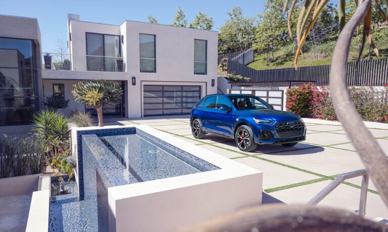 2025 Audi Q5 Exterior Parked In Driveway By House With Waterfall