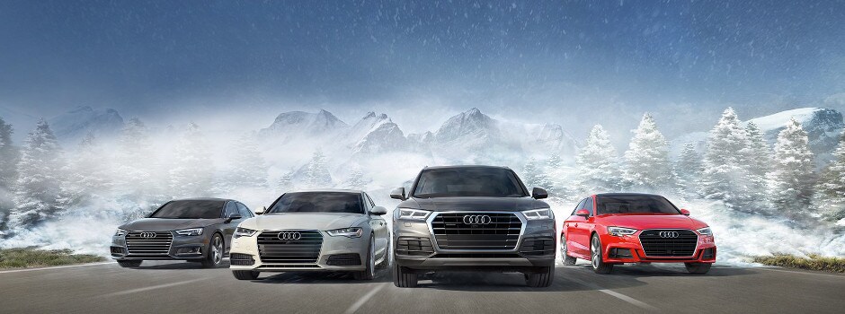 Audi Dealership near Wilmette, IL A group of Audi vehicles driving away from mountains