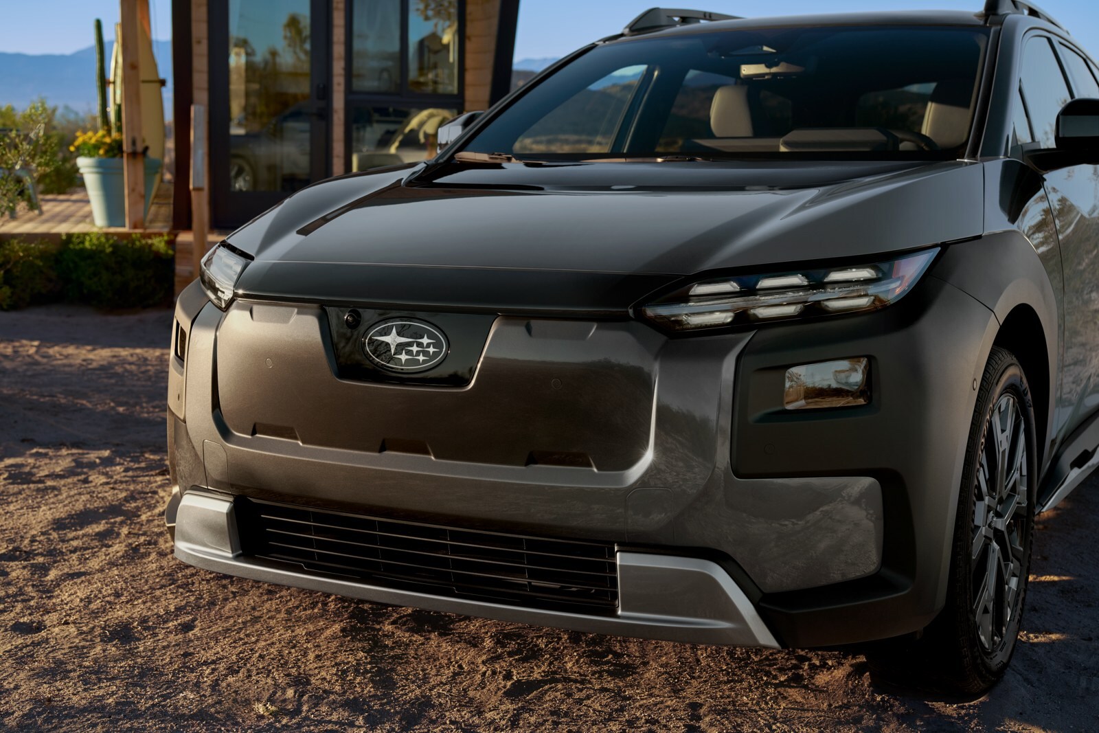 2027 Subaru Trailseeker Touring in Magnetite Gray Metallic outside a contemporary building