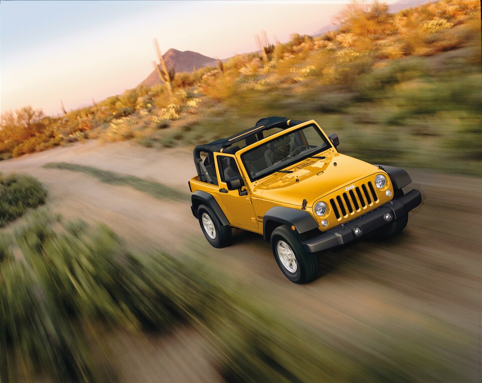 2018 Jeep Wrangler Sport-SUV yellow in motion.jpeg