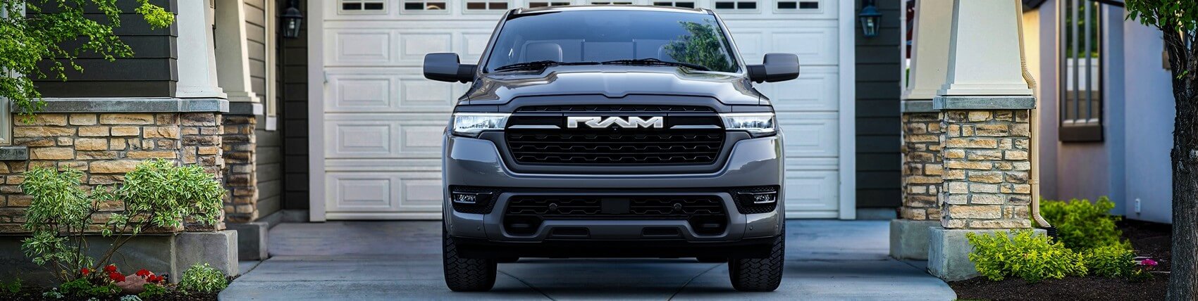 Front view of Ram 1500 parked in driveway in front of a house