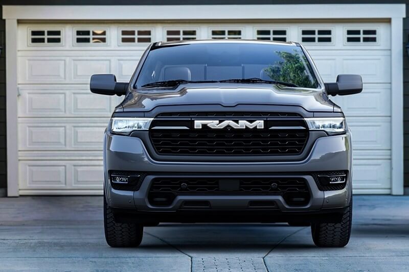 Front view of Ram 1500 Hybrid truck parked in front of house garage