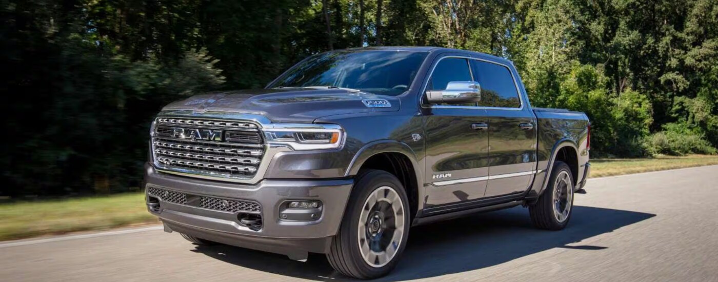 2027%20Ram%201500%20-%20trees.png Grey 2027 Ram 1500 driving down a rural road