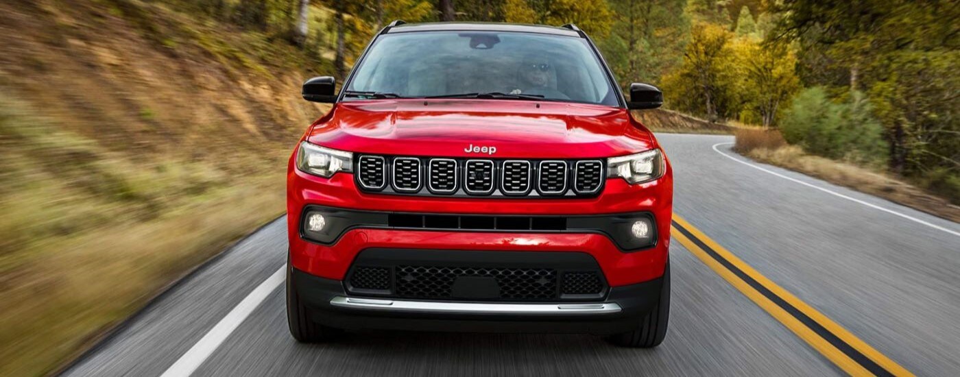 A red 2024 Jeep Compass front-view driving.