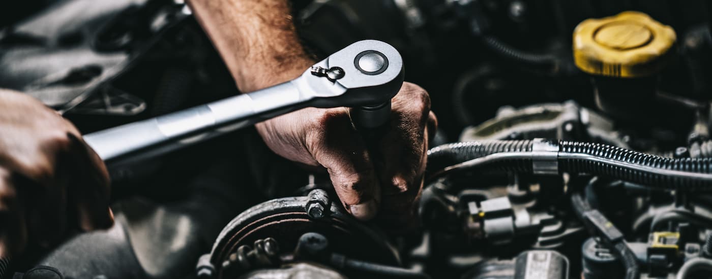 Close-up on a mechanic working on an engine.