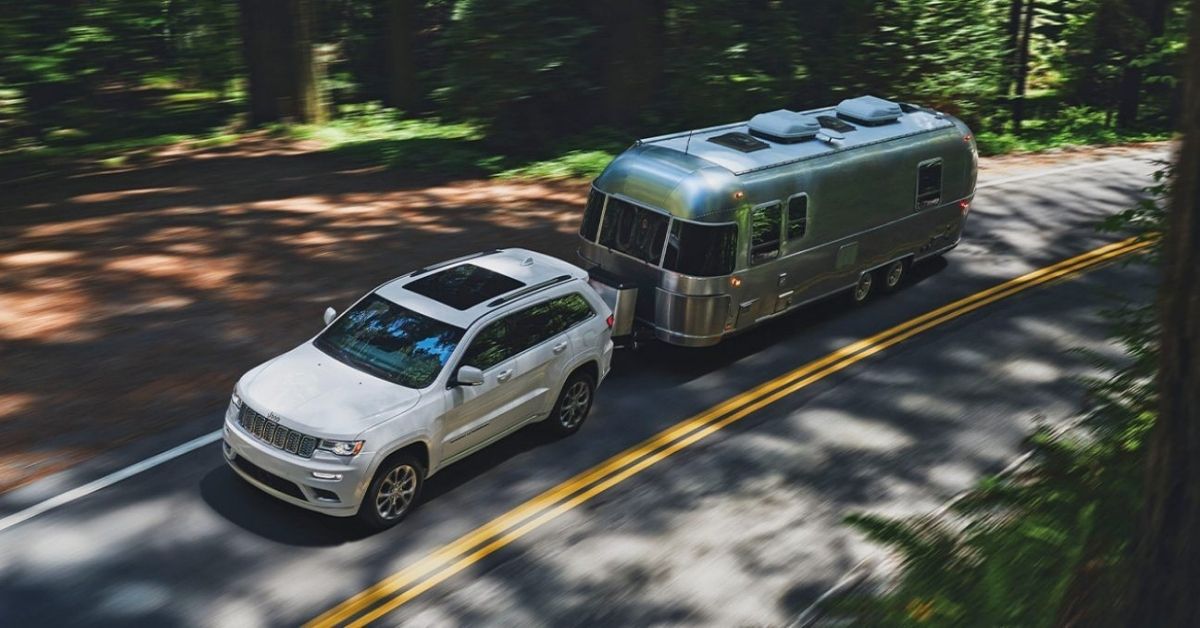 White 2021 Jeep Grand Cherokee Towing A Camper.jpg
