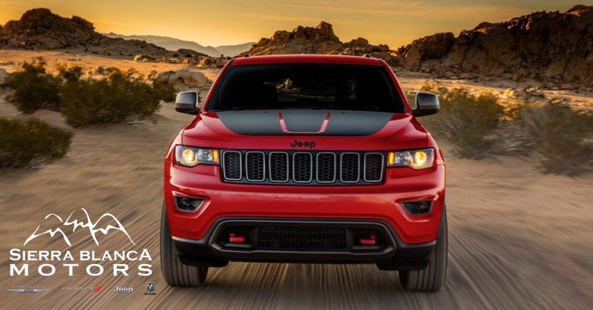 Red 2021 Jeep Grand Cherokee Driving In The Desert.jpg