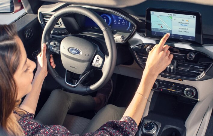 Woman using the cars infotainment system