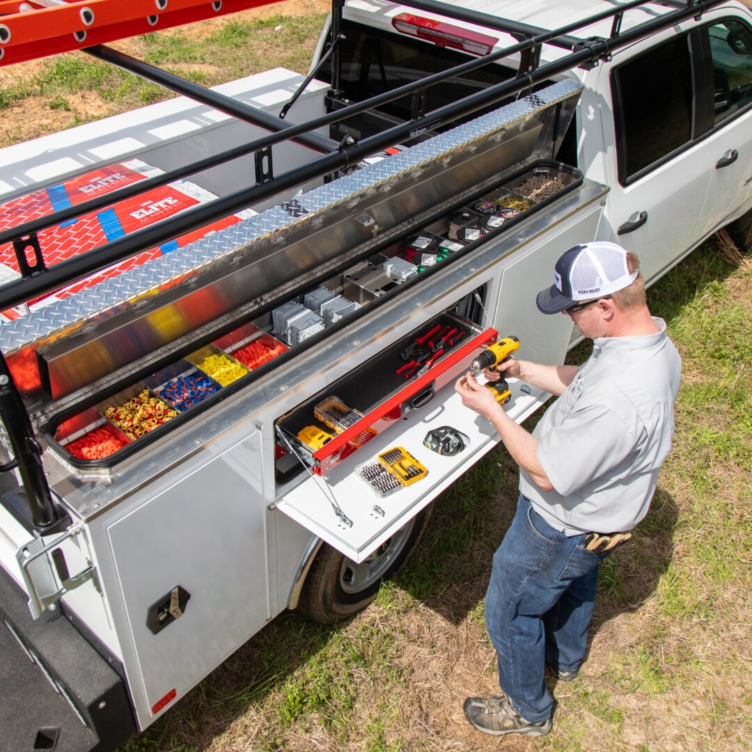 Organized flip-top compartment on a CM service body