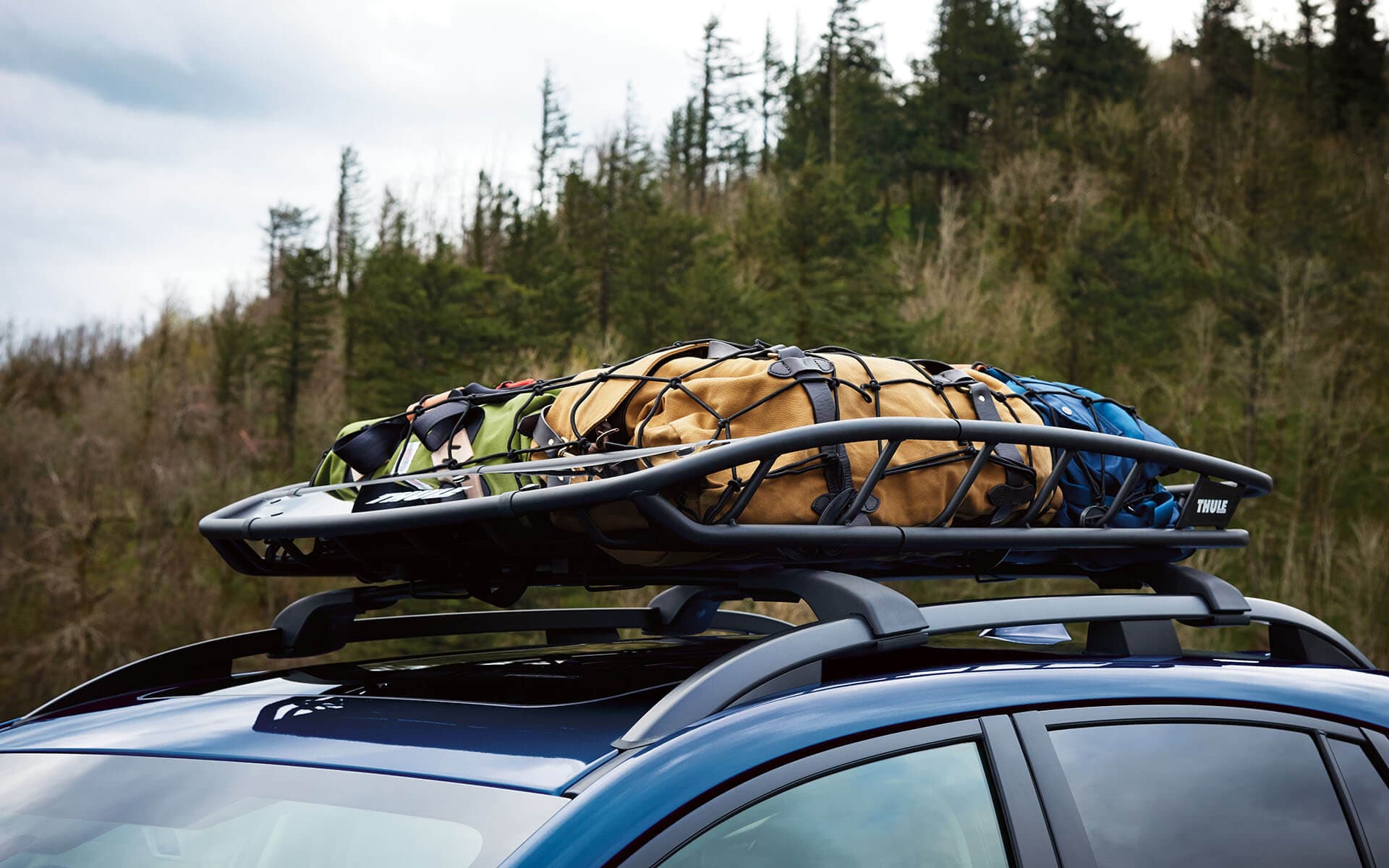 Close up of a Subaru Crosstrek's roof rails and Thule cargo rack