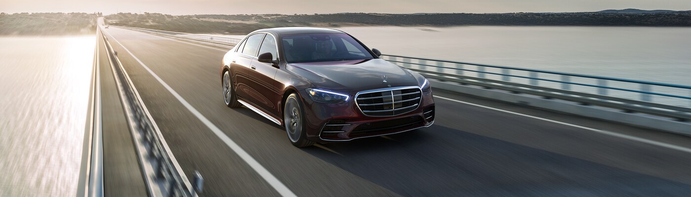 Mercedes-Benz S-Class Red Mercedes-Benz S-Class driving on a bridge