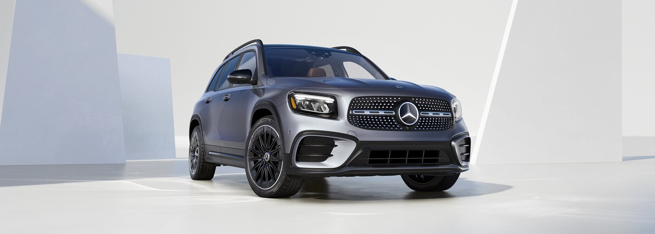 Mercedes-Benz GLB Grey Mercedes-Benz GLB parked in a white modern space