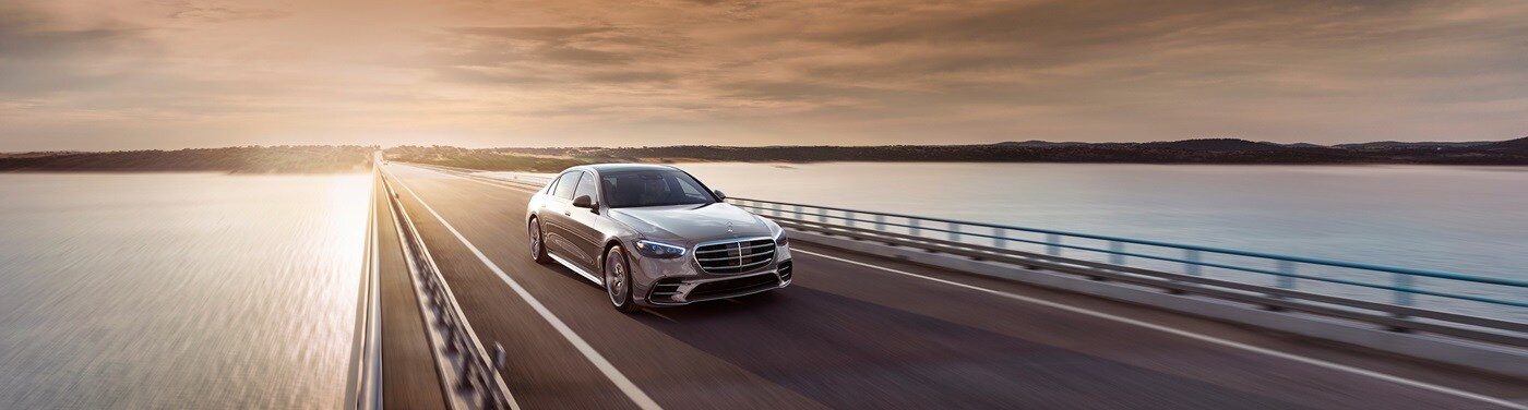 Mercedes-Benz S-Class White Mercedes-Benz S-Class driving on a bridge
