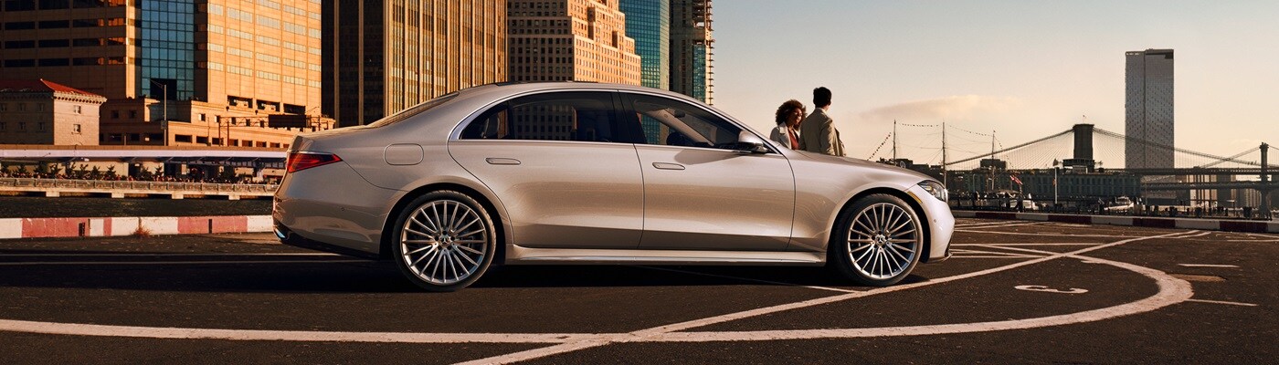 Mercedes-Benz S-Class White Mercedes-Benz S-Class parked in front of a modern house