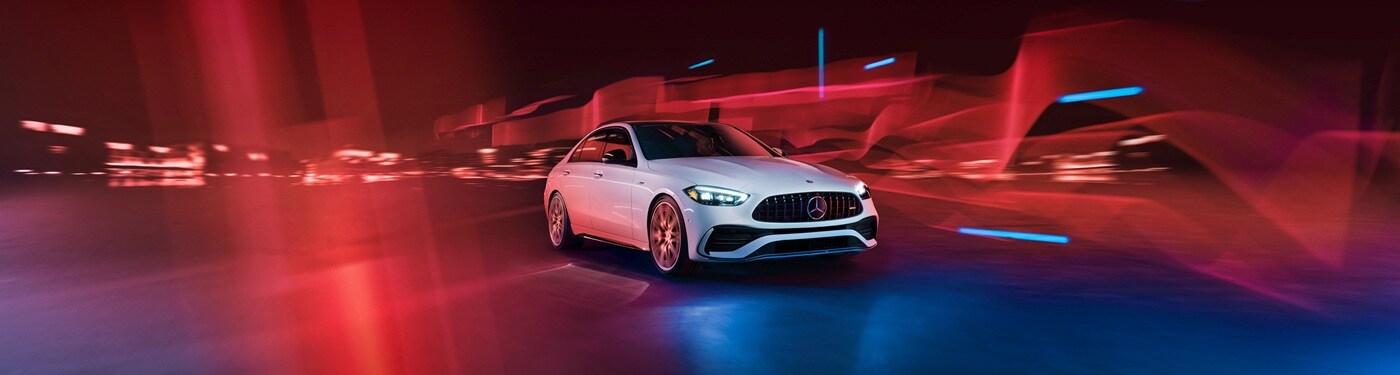 Mercedes-Benz AMG C-Class White Mercedes-Benz AMG C 43 sedan driving thru wavy lighting