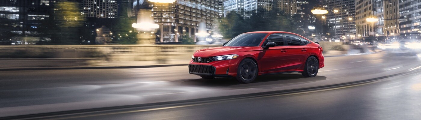 Honda Civic Si Red Honda Civic Si driving on a city street
