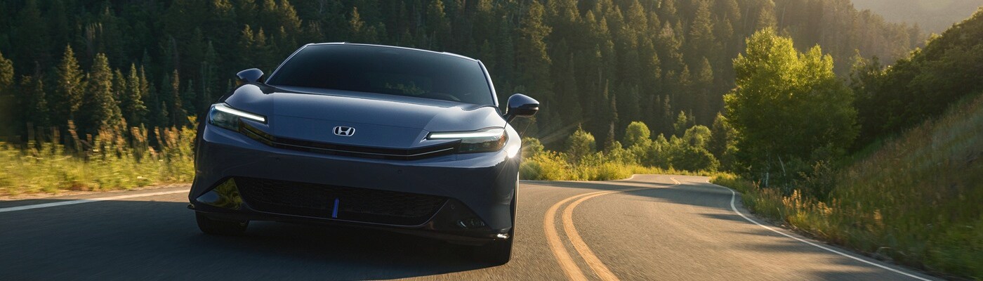 Honda Prelude Black Honda Prelude driving on a road in the woods