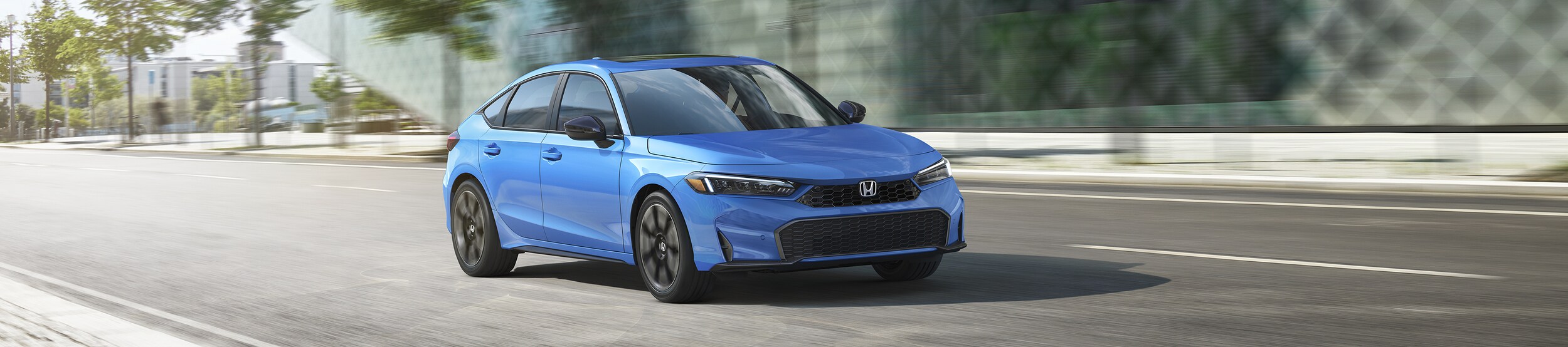 Honda Civic Sport Touring Hybrid Light Blue Civic Sport Touring Hybrid driving in a city