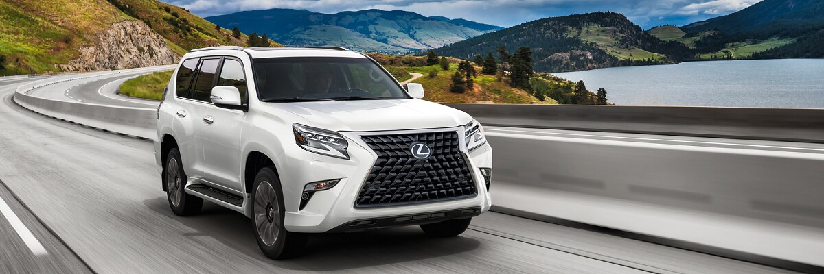 New Lexus GX White Lexus GX 460 driving by a lake