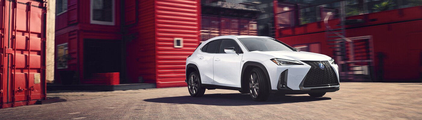 Lexus UX 250h 2023 Lexus UX 250h driving in an industrial area