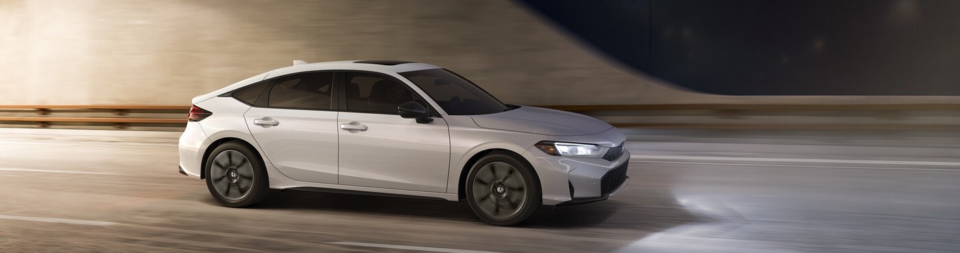Honda Civic Hatchback Civic Hatchback Sport Touring Hybrid driving in a city
