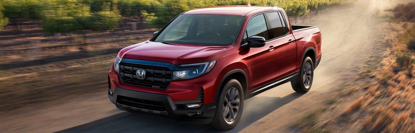 Honda Ridgeline Red Honda Ridgeline Sport driving thru a winery