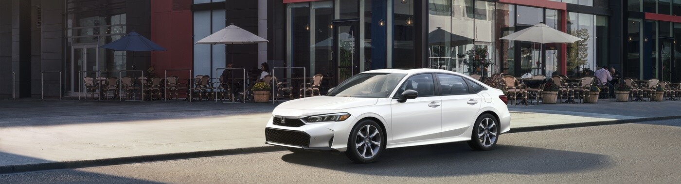 Honda Civic Sport Touring Hybrid White Honda Civic Sport Touring Hybrid parked in front of a cafe