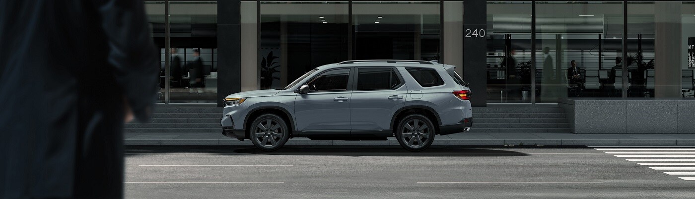 Honda Pilot Grey Honda Pilot Elite parked on a city street