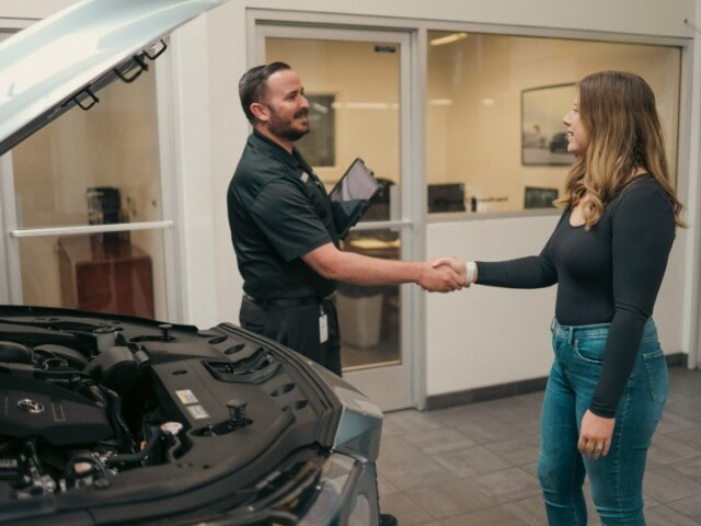 Lexus of Marin staff greeting a service customer with a handshake