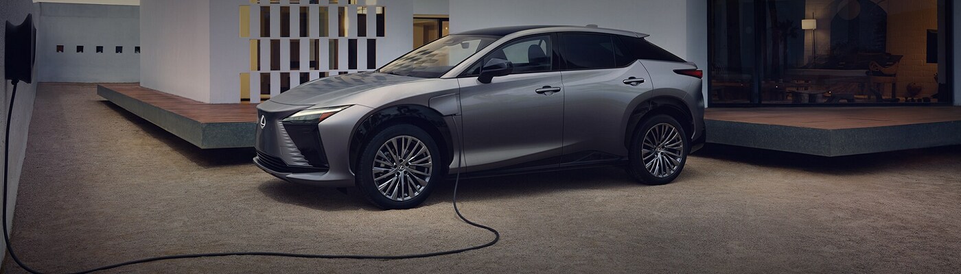 Lexus RZ 450e Gray Lexus RZ 450e parked and charging
by a modern home