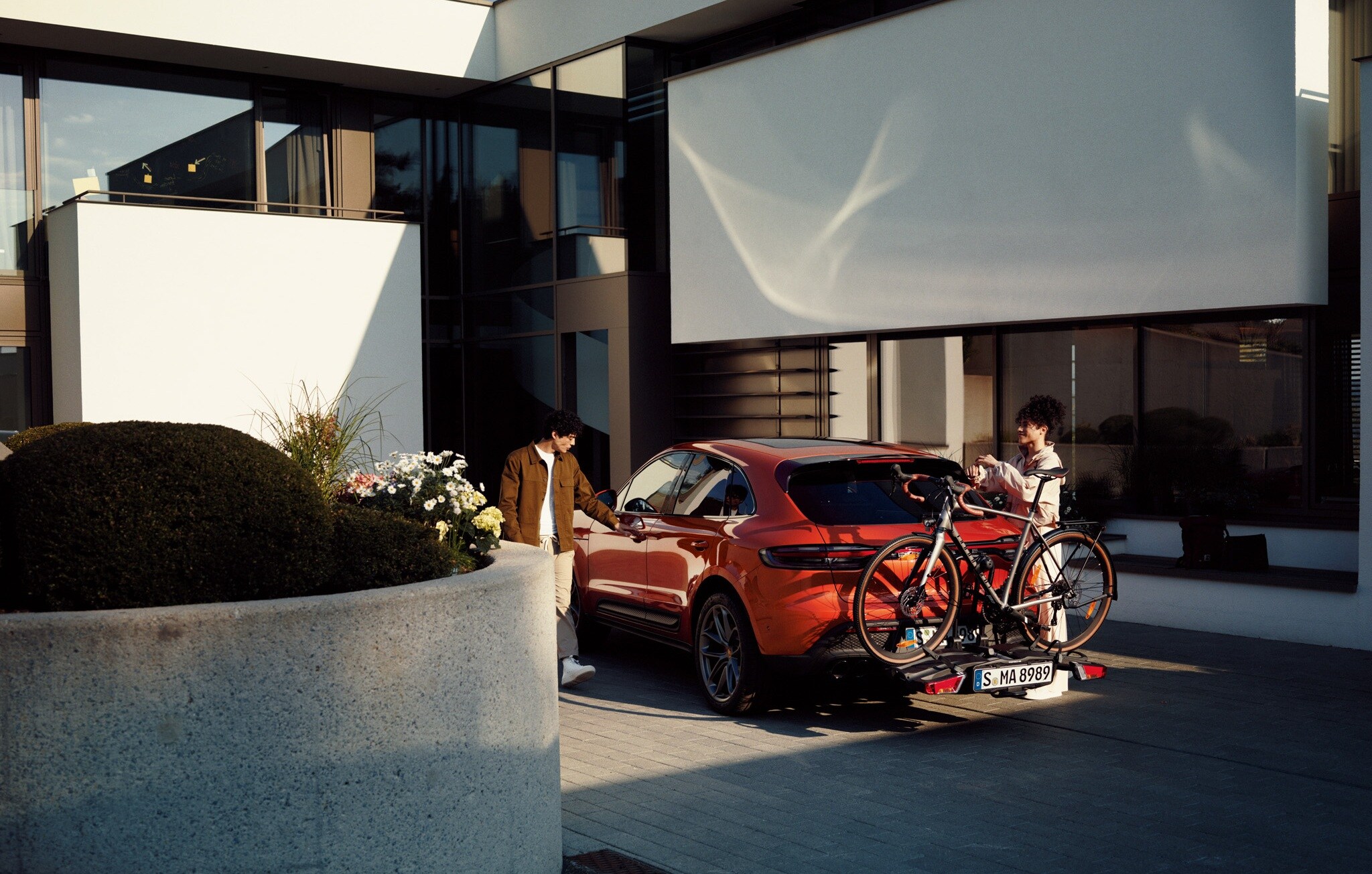 Porsche Macan Orange Porsche Macan being load with bicycles