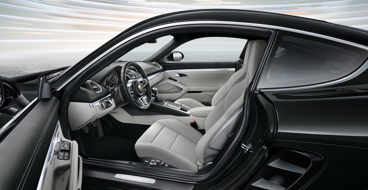 Porsche 718 Cayman interior interior view of a Porsche 718 Cayman with the driver's side door open