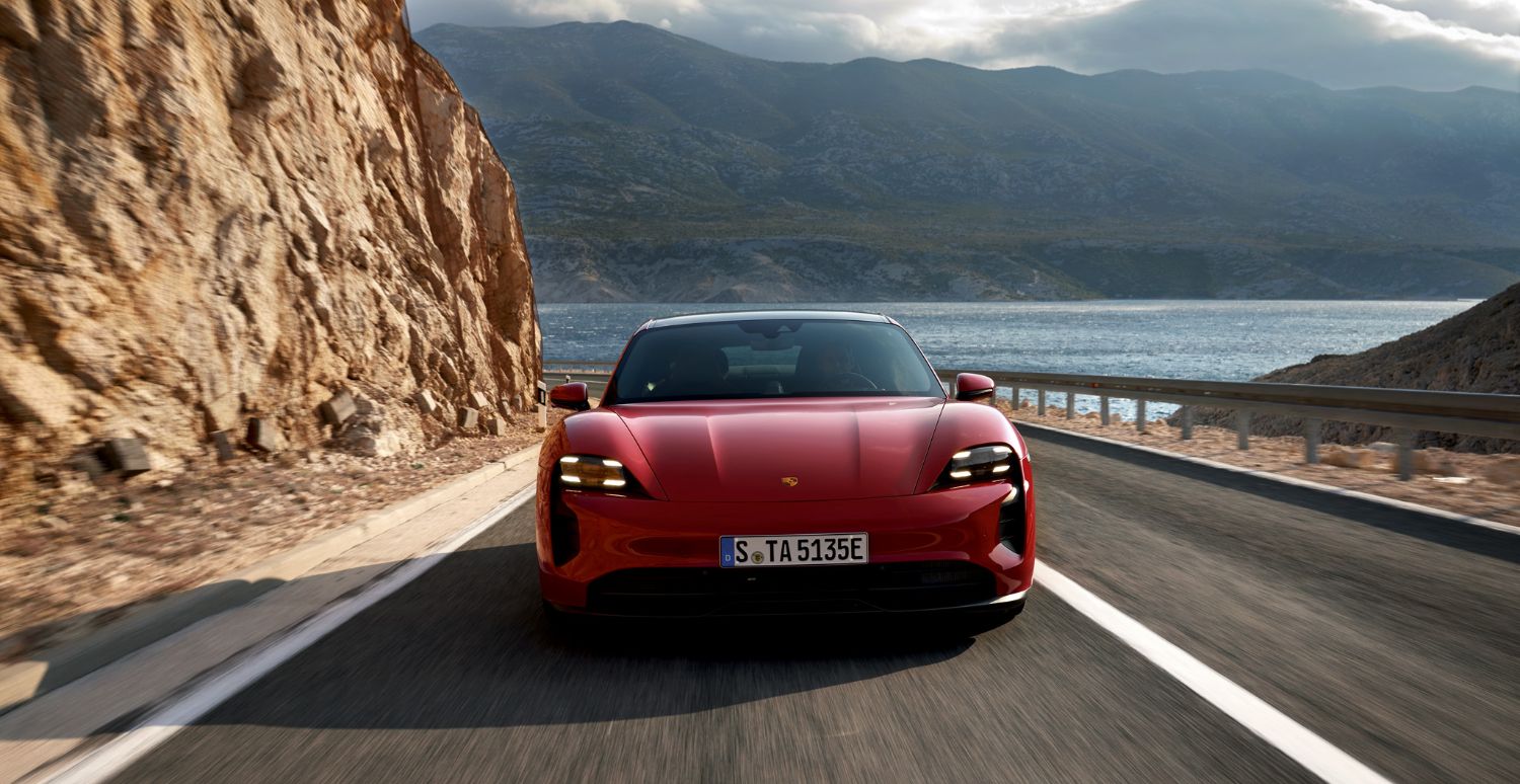 Porsche Taycan front view of a red Porsche Taycan on the road