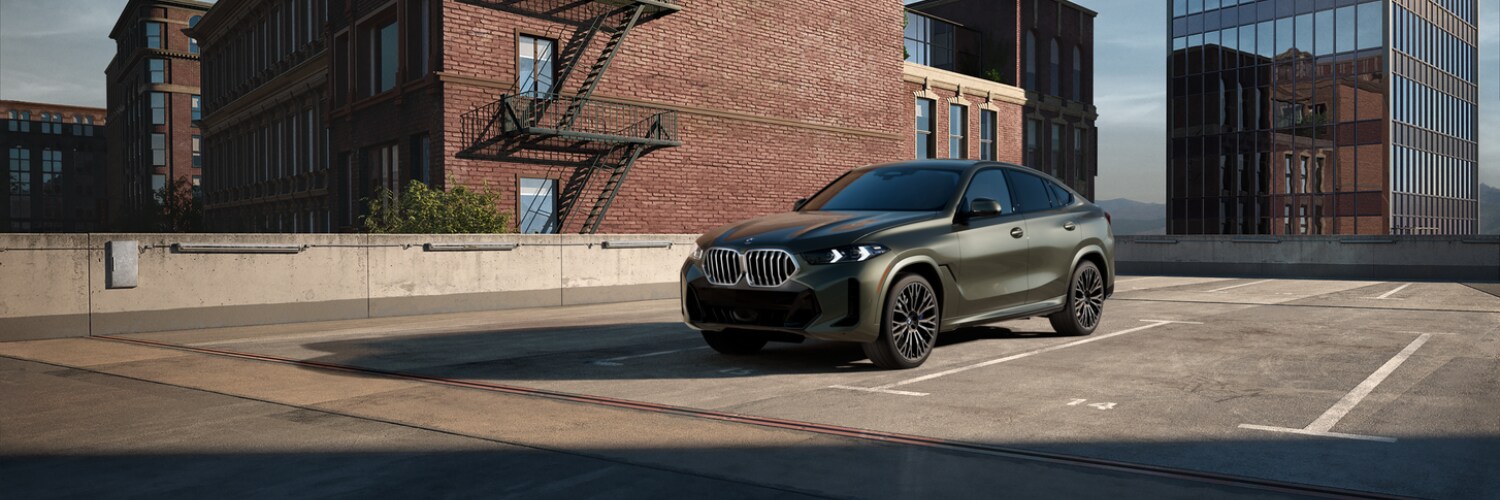 BMW X6 Grey BMW X6 SUV parked on the roof of a parking garage