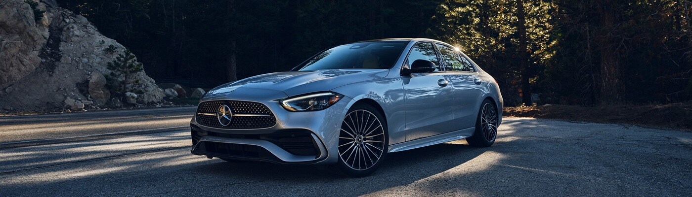 Mercedes-Benz AMG® C-Class Silver Mercedes-Benz AMG C 43 parked in the forest in some shade