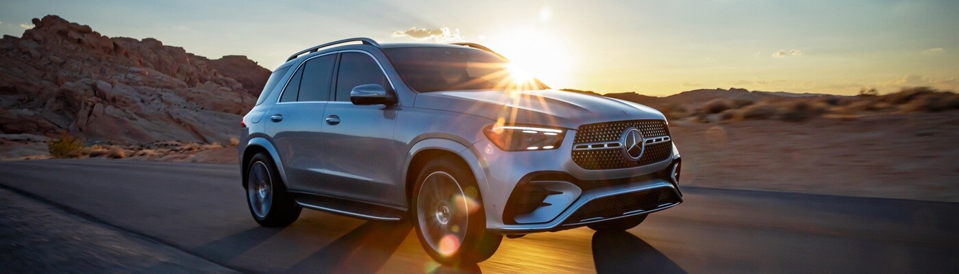 Mercedes-Benz GLE Silver Mercedes-Benz GLE 350 AMG driving on a road in the desert