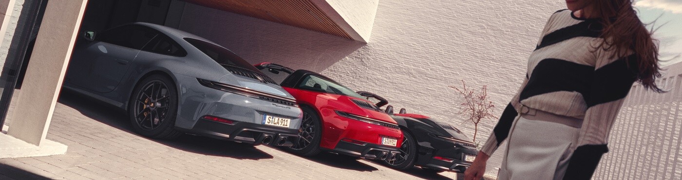 Porsche 911 Three 911 models parked underneath a modern house