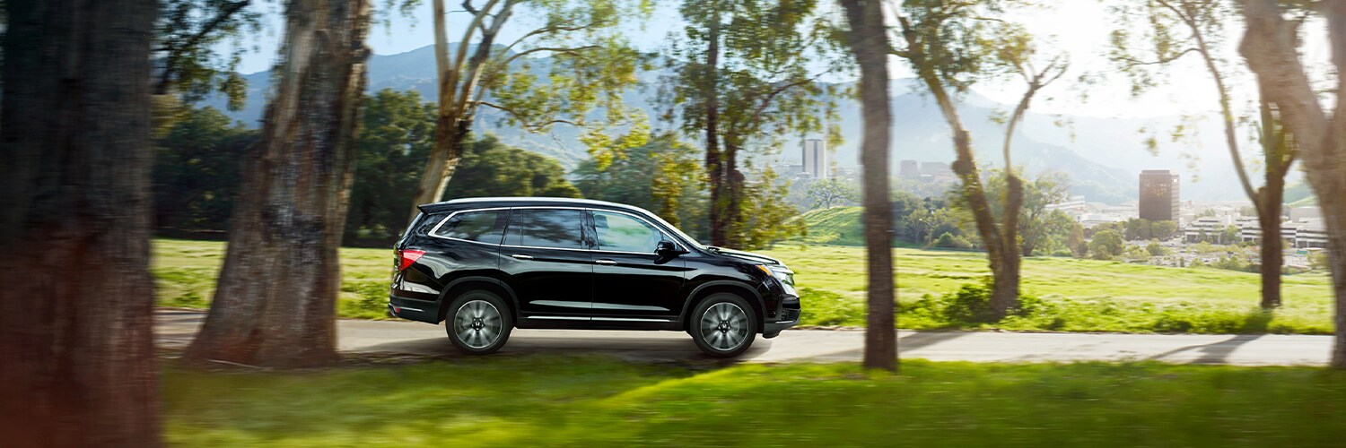 2022 Honda Pilot Black Pilot driving through trees