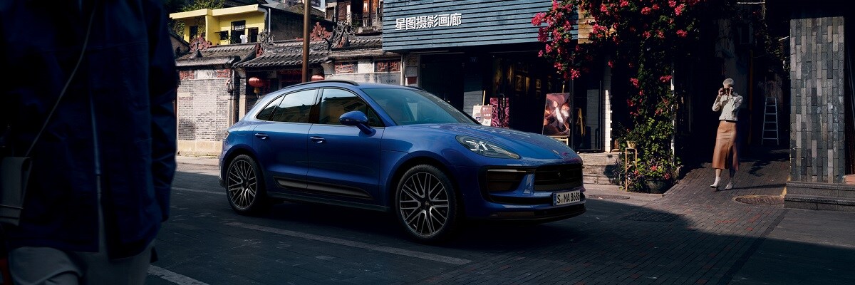 Porsche Macan Blue Porsche Macan parked in a city street