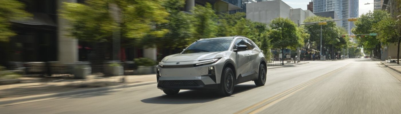 Toyota C-HR Toyota C-HR with Wind Chill Pearl Paint driving in the city