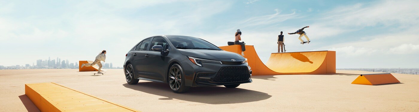 Toyota Corolla SE Grey Toyota Corolla SE parked by an orange skatepark