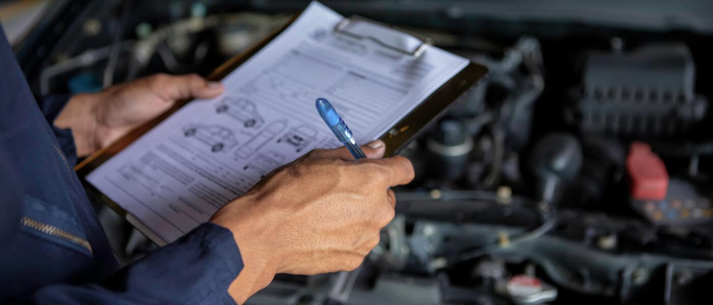 Service technician close up inspecting vehicle