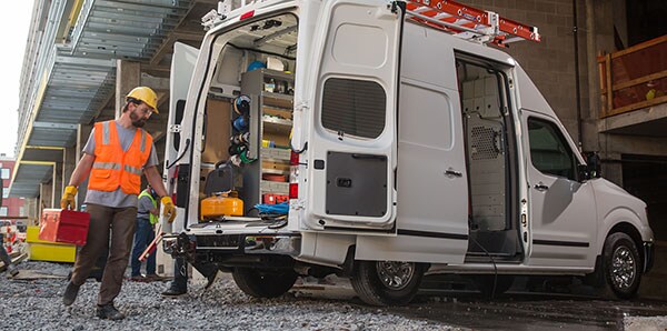A construction worker loading up an NV Cargo Van