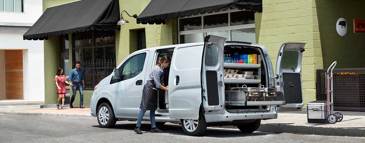 A food vendor unloading a NV Cargo Van.