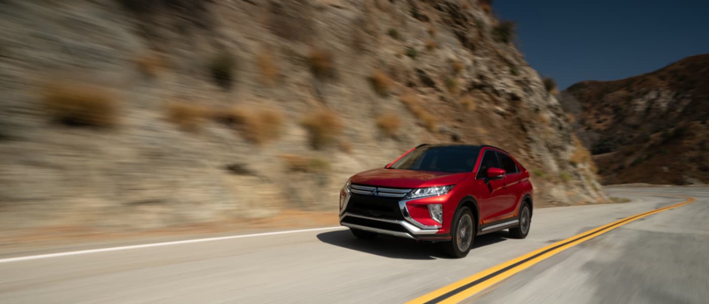 Red 2019 Mitsubishi Eclipse Cross driving down hill